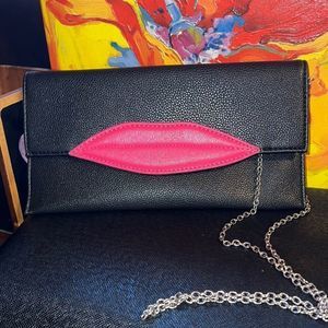 Black clutch purse with pink lips. Man made material.